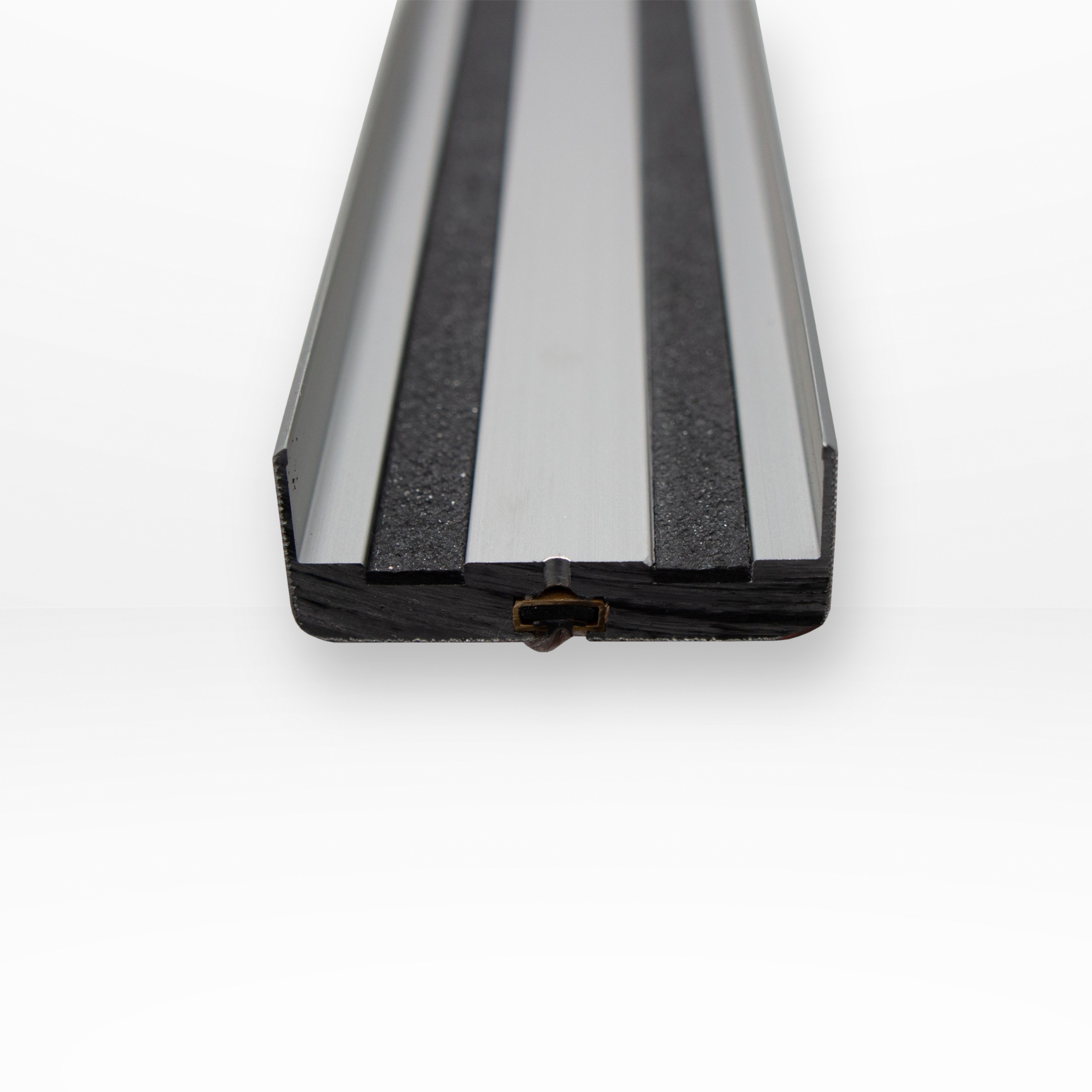 Close-up of a black and clear plastic strip on a white background